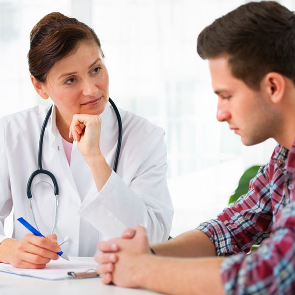 doctor talking to her male patient at officePlease see similar images here: